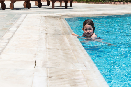 Little girl swimming in a poolの写真素材