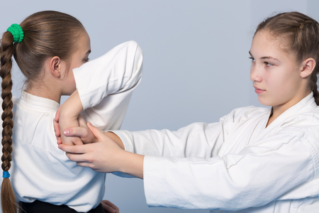 Two girls practice Aikidoの写真素材