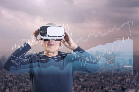 An old man using a virtual reality headsetの写真素材