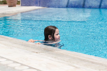 Little girl swimming in a poolの写真素材