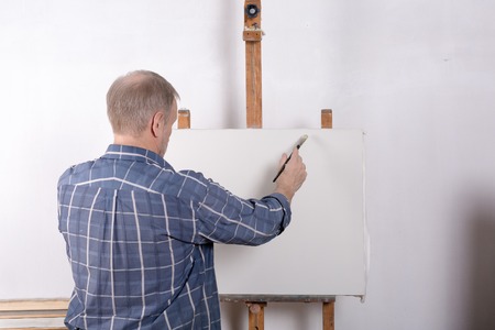 An artist in studio white canvasの写真素材