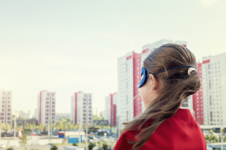 Superhero kid against urban backgroundの写真素材