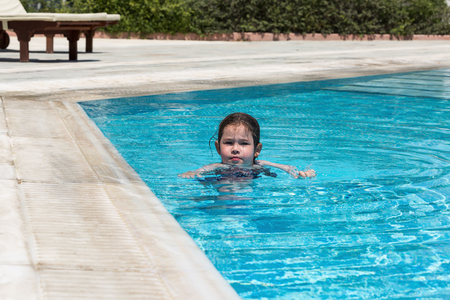 Little girl swimming in a poolの写真素材