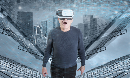 An old man in VR headset against a city buildings background.の写真素材