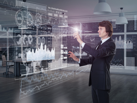 A businessman using diagrams on virtual displayの写真素材