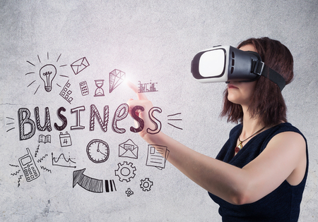 Woman in VR headset against a concrete wall backgroundの写真素材