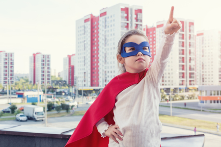 Superhero kid against urban backgroundの写真素材