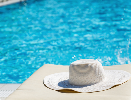 White hat left by a swimming poolの写真素材
