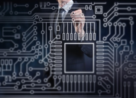 A businessman touching an electronics circuitの写真素材