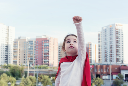 Superhero kid against urban backgroundの写真素材