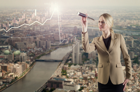 A businesswoman looking with spyglass for best dealの写真素材