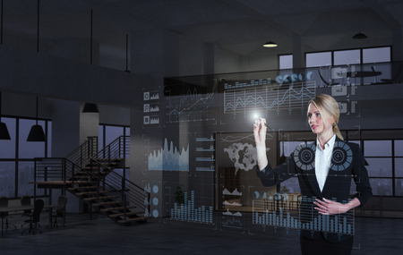 A businesswoman using diagrams on virtual displayの写真素材