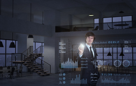 A businessman using diagrams on virtual displayの写真素材