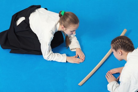 Two girls in hakama bow on Aikido trainingの写真素材
