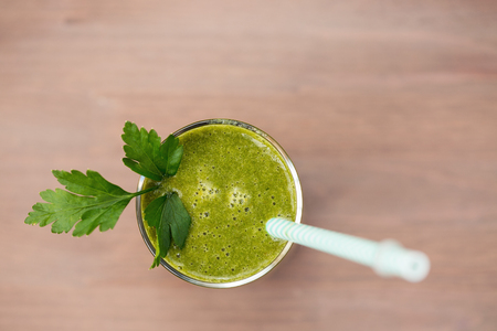 A green smoothie with parsley in a glassの写真素材