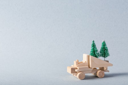 Miniature wooden truck with x-mas tree on is topの写真素材