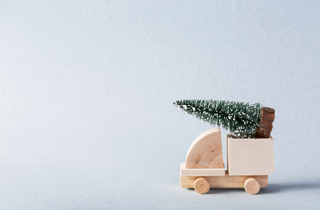 Miniature wooden truck with x-mas tree on is topの写真素材