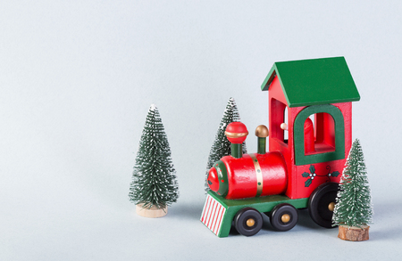 Wooden toy train surrounded by christmas treesの写真素材