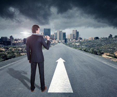 Corporate warrior with japanese sword against cityscape on the horizonの写真素材