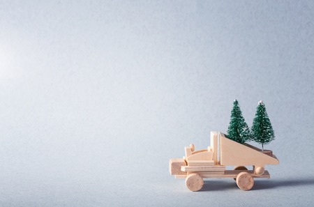 Wooden toy truck with christmas tree on is topの写真素材