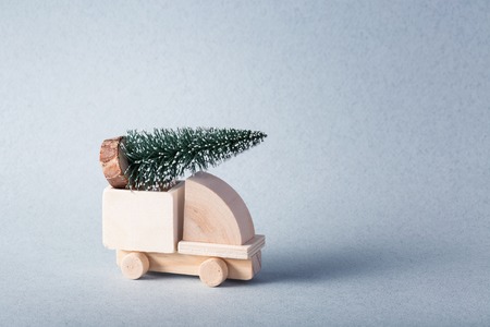 Wooden toy truck with christmas tree on is topの写真素材