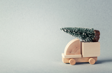 Wooden toy truck with christmas tree on is topの写真素材