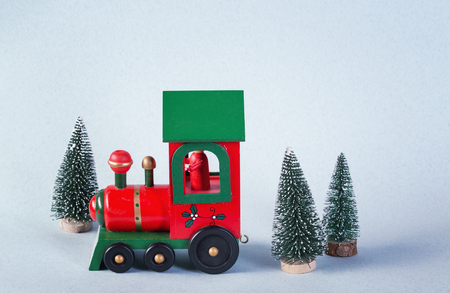 Wooden toy train surrounded by christmas treesの写真素材