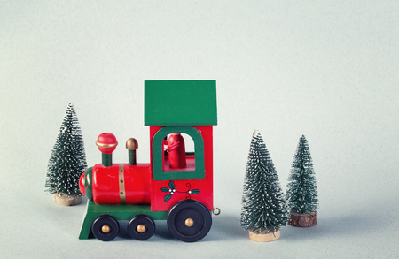 Wooden toy train surrounded by christmas treesの写真素材