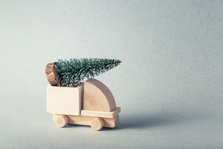 Wooden toy truck with christmas tree on is topの写真素材