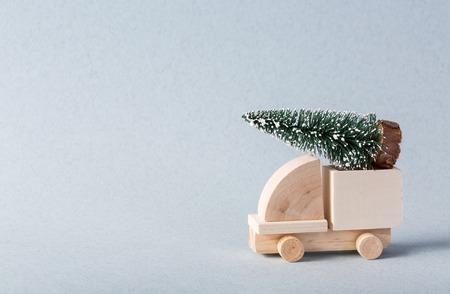 Wooden toy truck with christmas tree on is topの写真素材