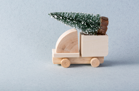 Wooden toy truck with christmas tree on is topの写真素材