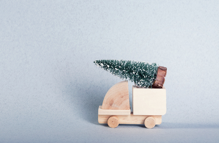 Wooden toy truck with christmas tree on is topの写真素材