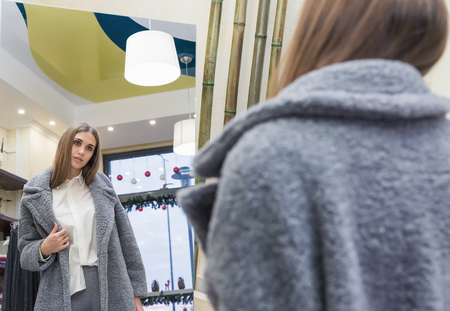 A beautiful woman shopping in a fashion storeの写真素材