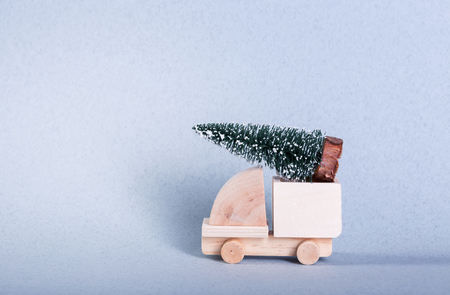 Wooden toy truck with christmas tree on is topの写真素材
