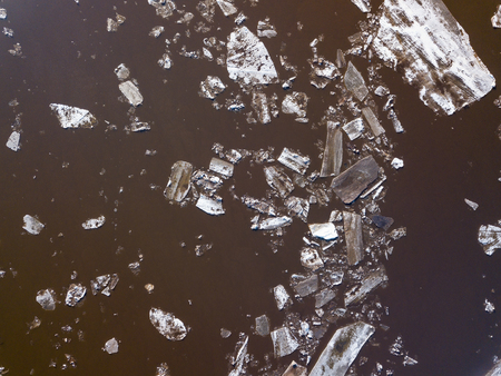 The ice floes floating on the river. The ice drift in spring timeの写真素材