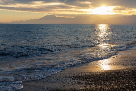 Beautiful sunset at beach with golden sun reflection on the seaの写真素材