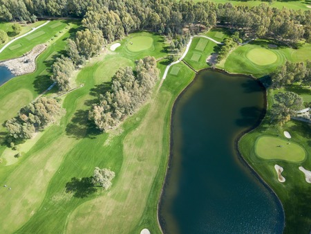 Aerial photo of green golf fields in springの写真素材