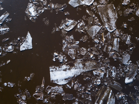 The ice floes floating on the river. The ice drift in spring timeの写真素材