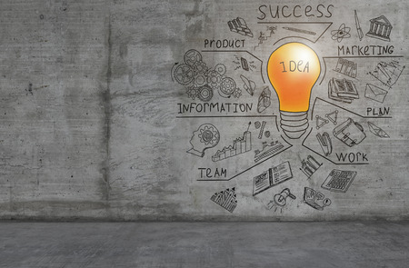 A colorful light bulb and business sketch drawn on a concrete wallの写真素材