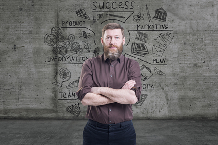 Handsome businessman against a concrete wall with sketch drawn on itの写真素材