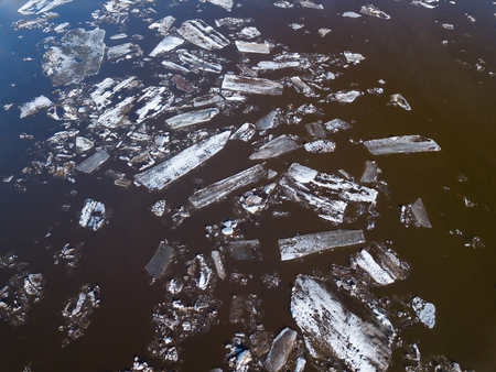 The ice floes floating on the river. The ice drift in spring timeの写真素材