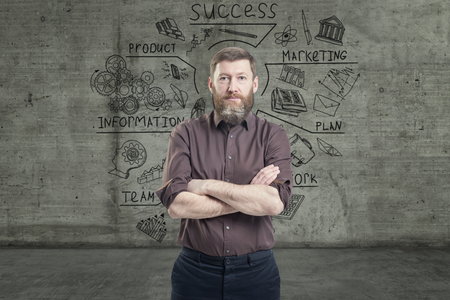 Handsome businessman against a concrete wall with sketch drawn on itの写真素材