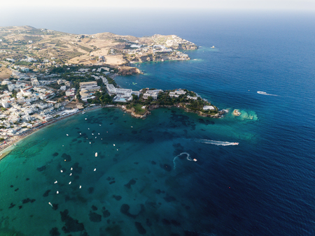 Aerial drone photo of beautiful cretan village by the seaの写真素材