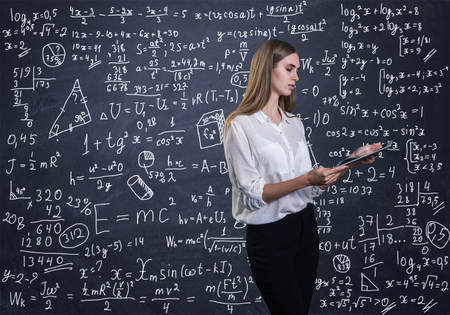 Beautiful woman thinking how to solve a math problemの写真素材