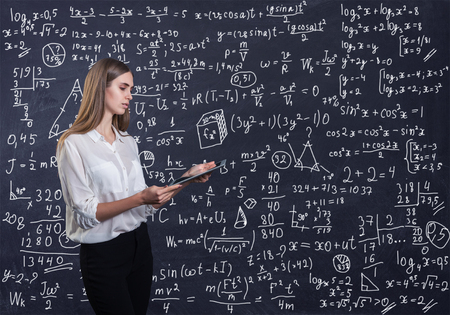 Beautiful woman thinking how to solve a math problemの写真素材