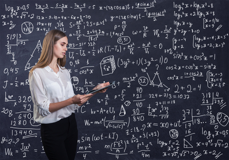 Beautiful woman thinking how to solve a math problemの素材 [FY310123757737]