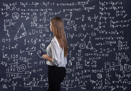 Beautiful woman thinking how to solve a math problemの写真素材
