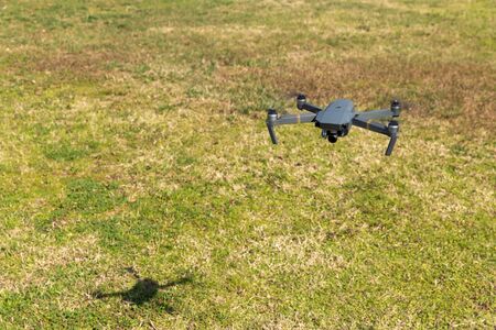 A drone with digital camera flying in the parkの写真素材