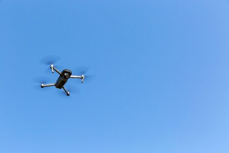 A drone flying against the blue skyの写真素材