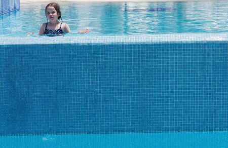 Little cute girl swimming in a poolの写真素材